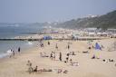 People enjoying the sunny weather on Boscombe Beach in Bournemouth (Andrew Matthews/PA)