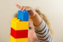 A preschool age child playing with plastic building blocks (Dominic Lipinski/PA)