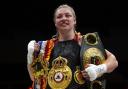 Lauren Price celebrates with belts following the IBA and WBA world Welterweight victory over Jessica McCaskill (Bradley Collyer/PA)