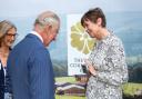 Heather Hancock, chair of trustees for The Royal Countryside Fund, presents King Charles III with the gold pin