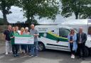Representatives from the Great North Air Ambulance Service pick up the cheque for £1,175 which was fundraised by the Bellingham caravan owners