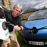 Herbie Newell charging up his electric car at the Humshaugh Village Hall charging point. 	        Photo: HX271980