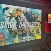 Wil Cheung posing in front of the new Mission: Impossibe film he was an extra in