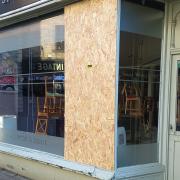 The damaged window at Small World Cafe