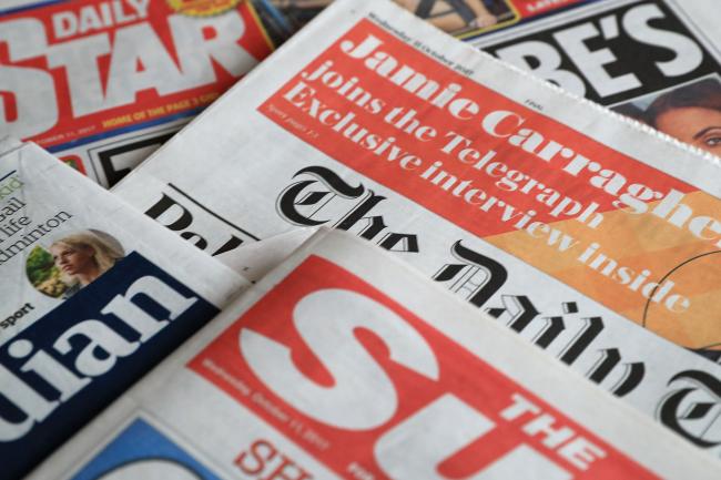 A collection of British newspapers.