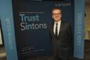 Mark Quigley, managing partner of Sintons, with the firm’s new branding.