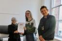 High school student Robbie Jarvis receiving the award from Lucia Fisher of Hexham Art Club, with art teacher Will Pym