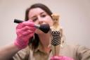 Exhibition curator Danielle Thom holds first edition Barbie doll (James Manning/PA)