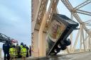 The lorry was left dangling off the Clark Memorial Bridge over the Ohio River (Louisville Division of Fire via AP)