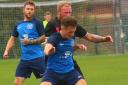 Haltwhistle Jubilee striker Matty Kilby holds off a determined challenge from an AFC Newbiggin defender