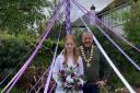 May Queen Orla Bolton with the mayor underneath a maypole in her Knutsford garden