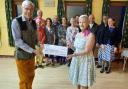CHARITY: Catherine Dixon presenting Brian Massey, Chair of Torch Centre Management Committee, with a £300 cheque
