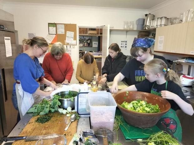 Hexham Courant: COOK: Volunteers in the kitchen preparing food. Image: Kate Maughan