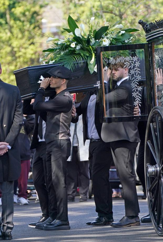 Hexham Courant: Max George and Jay McGuiness of The Wanted carry the coffin at the funeral of their bandmate. (PA)