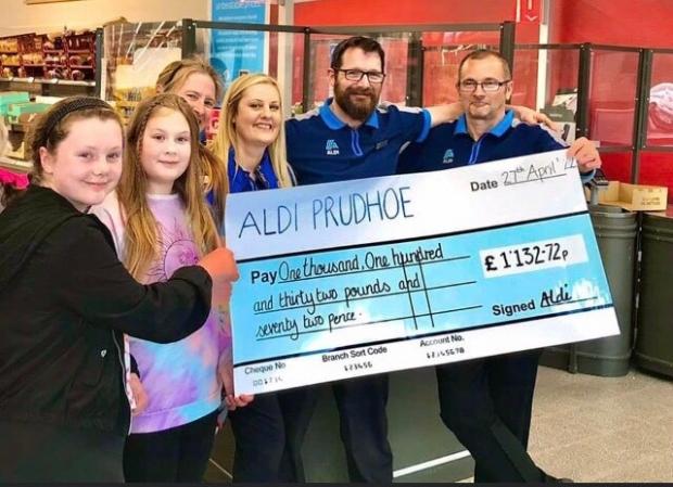 Hexham Courant: CHARITY: Two of the children involved with Prudhoe Youth Project, with some of the Aldi staff. Image: Aldi