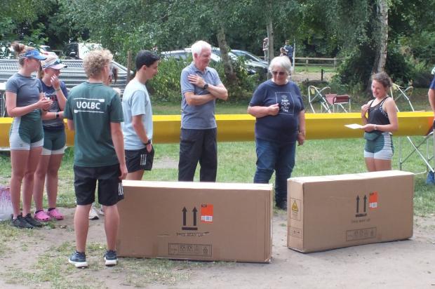Hexham Courant: Captains Ned Gibbard, Ben Ryrie, Zara Holtham and Christian Ryan presenting Geoff and Pauline with two loungers at the end of the BBQ - now that they think they will have time to sit on them!