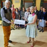 CHARITY: Catherine Dixon presenting Brian Massey, Chair of Torch Centre Management Committee, with a £300 cheque