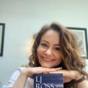 Author LJ Ross with a copy of her book, Holy Island
