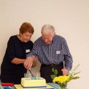 June and Neville cutting the cake