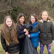 (L-R) Lola Gilbertson, Jeanie Officer, Emilia Fairless, Maggie Officer with one of the bags of litter