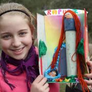 Egg decorating winner Maia Gray shows off her creation of Rapunzel at Hareshaw Lin, in Bellingham