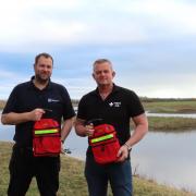 Alex Lister and Carl Bell with the two new defibrillators for Northumberland Wildlife Trust.