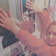 Carys Laidler, of Hexham's Sele First School, pictured with a photograph of herself taken by Helen Smith as part of an exhibition at the Queen's Hall Gallery of work that depicts what excites children and what makes them happy, confident achievers