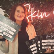Fiona Charlton, owner of Wellness and Beauty by Fi, with her qualification certificates to perform various skin treatments
