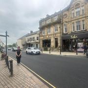 Shannon Currah from Saks Hexham next to the newly resurfaced road